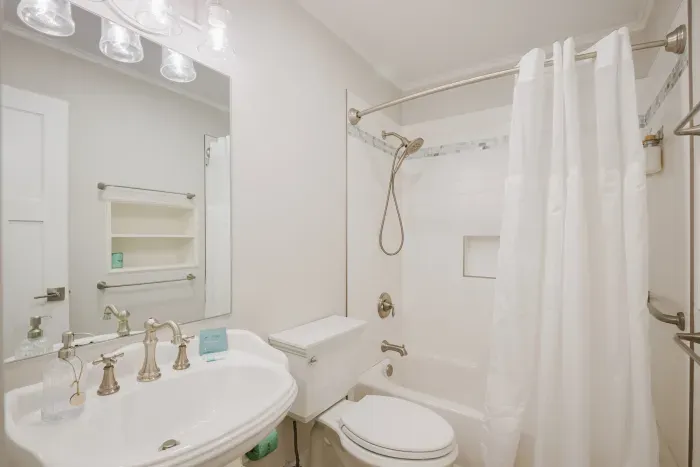 Bright, spotless full bath with tub-shower combo and elegant finishes