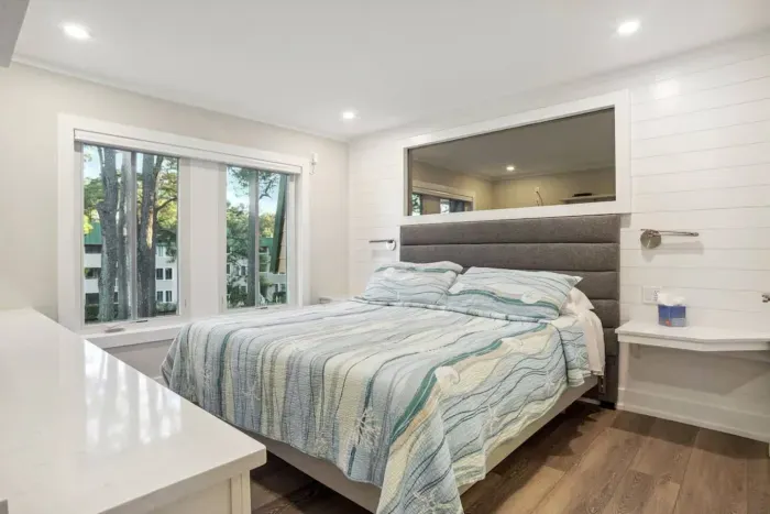 Primary bedroom with wide windows for fresh air