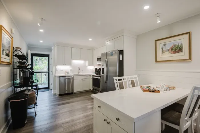 Bright modern kitchen with island seating and stainless steel appliances
