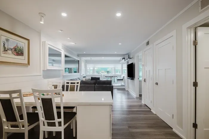 Bright open-concept dining and living space with big windows