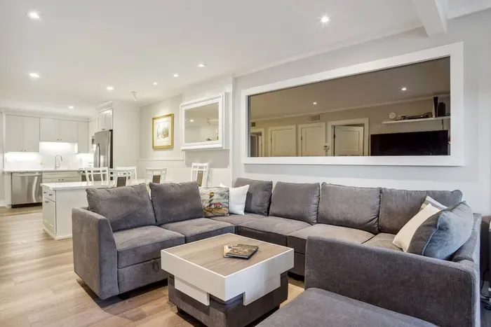 This spacious living room offers a harmonious blend of functionality and aesthetic appeal.
