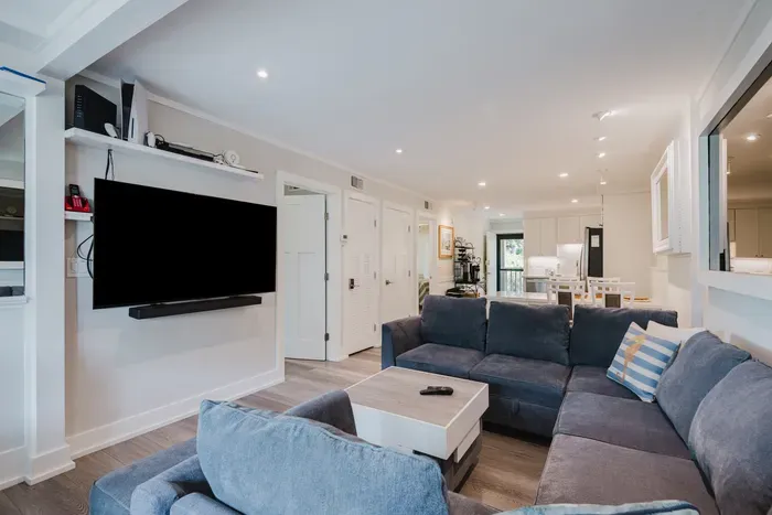 Bright open living area with large sectional and modern kitchen