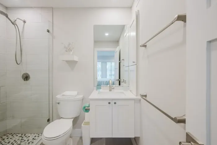 Bright spa-style bathroom with glass shower and sleek modern vanity