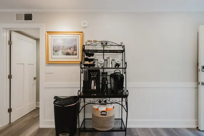 Convenient guest coffee station with stylish shelving and cozy charm