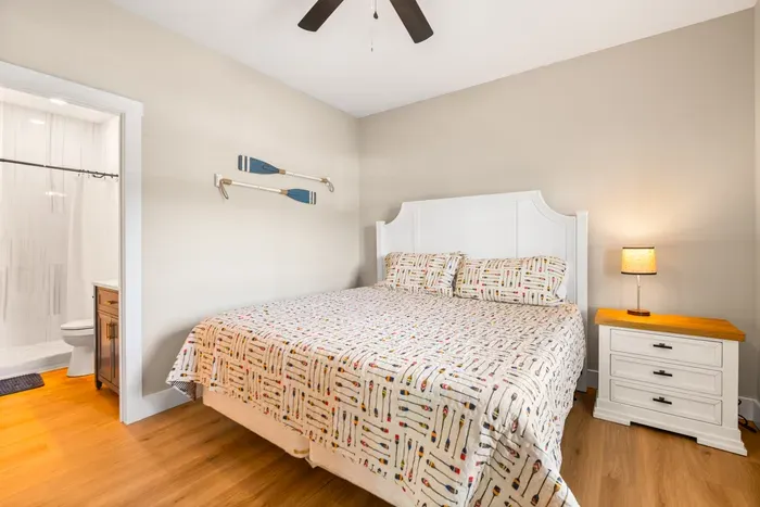 King bed with a tiled walk-in shower right off the room. Quiet, private, and steps from the lower-level den.
