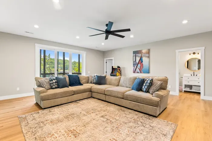 Second living area with its own sectional, arcade game, and full bath. Slider opens to the lower deck for straight-in-from-the-lake access.