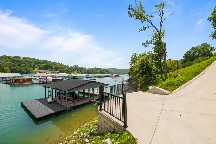 Your covered slip and swim deck, with a floating platform and lounge chairs. The concrete pad ends right at the gate.