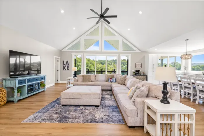 Big screen, big couch, big windows. Deck access right off the main living space for easy in-and-out all day.