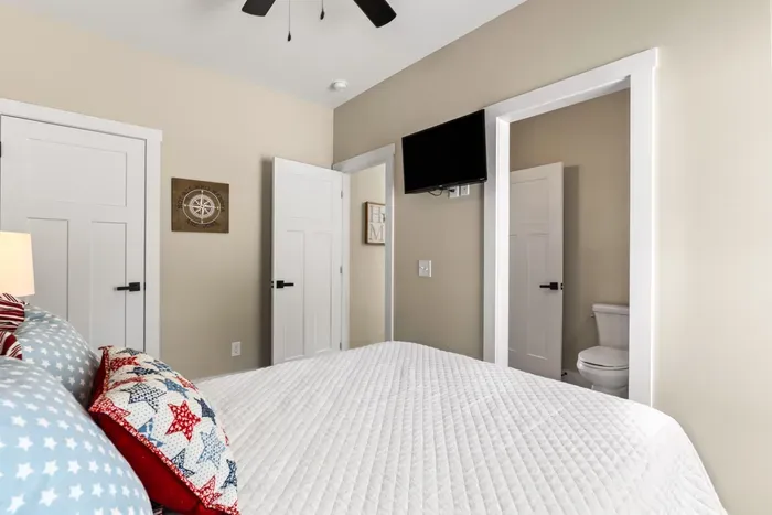 Wall-mounted smart TV, a closet of your own, and a private bath right off the room. Good landing spot for whoever wants an early night.