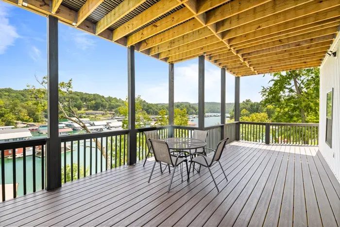 Second covered deck at the walkout level, with a table for four and the same water view. Shaded most of the day.