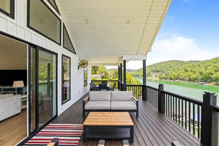Two seating areas plus a dining table under cover. Wall fans keep it comfortable even in August.