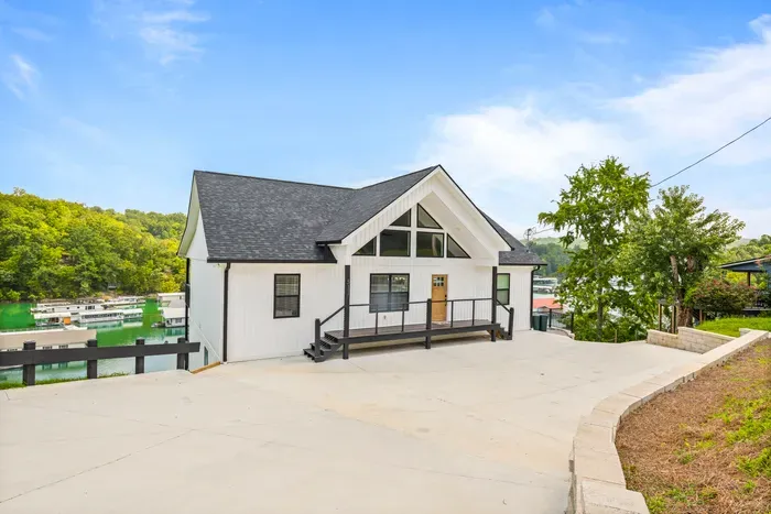 Stylish hillside lake house overlooking the marina, surrounded by scenic views and offering ample parking.