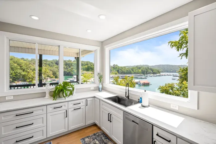 Best seat in the house might be at the sink. Wraparound windows look straight out over the marina and the cove.