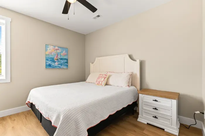 Quiet lower-level room with a king bed and two windows. Simple, bright, and easy to sleep in.