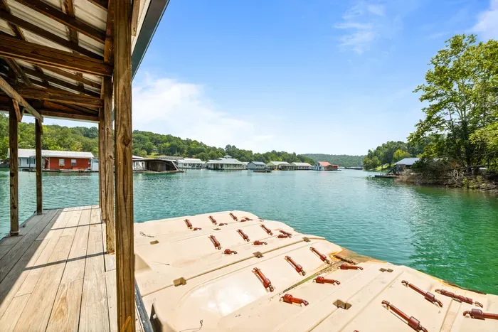 Shade on the dock, clear green water, and the swim platform right there. Best spot on the property for an afternoon.