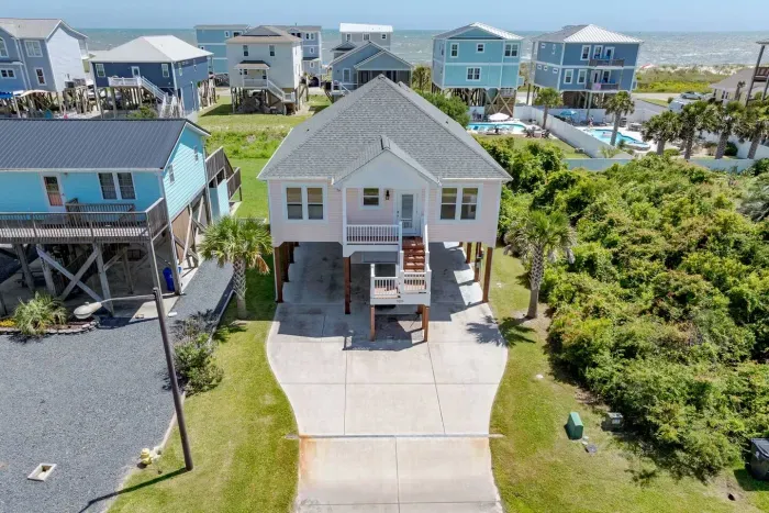You simply CANNOT beat the location! With ocean views and just a short walk to the beach!  It's the cutest PEACH beach house in Oak Island!