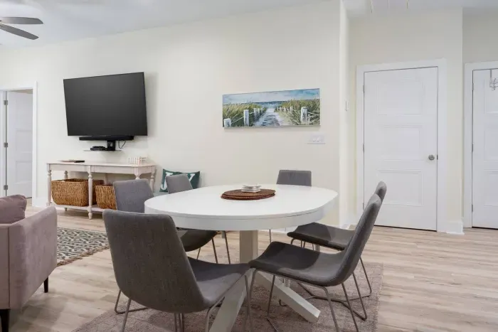 There's a dining table with seating for 8 plus stools at the kitchen island.