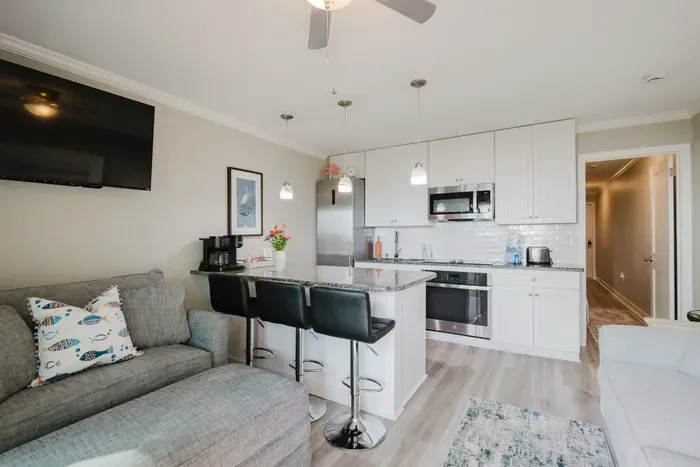 Full kitchen with cooktop, wall oven, microwave, dishwasher, and a peninsula that seats three. Cook a real dinner or just reheat leftovers from Skull Creek.