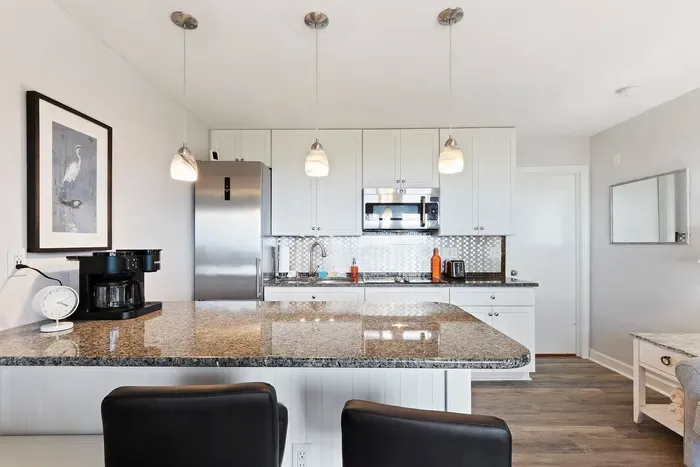 This modern design and well-lit space of this kitchen create a cheerful atmosphere