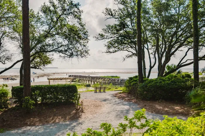 The boardwalk to Fish Haul Beach is steps from your door. Port Royal Sound has a wide tidal range — expect broad sand flats at low tide and a calm, swimmable shoreline as it comes in.
