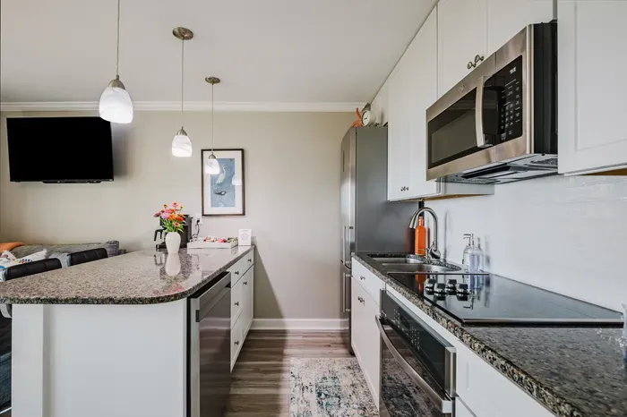 Granite counters, stainless appliances, and a coffee bar with a Keurig and drip brewer — everything you need for breakfast before the beach.