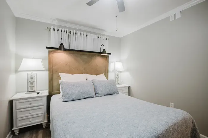 Turn on the headboard sconces and settle in. Nightstands on both sides, an alarm clock, and outlets within easy reach of the bed.