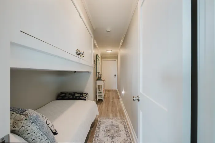 The built-in bunk sits in the hallway alcove near the entry — a cozy, tucked-away spot that kids tend to claim first. :)