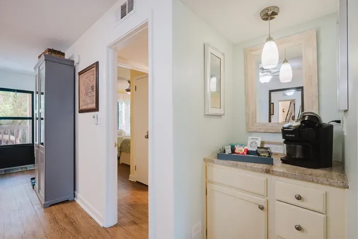 Welcoming hallway with convenient coffee bar and bright, airy touches