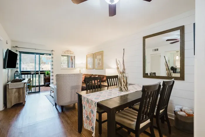 Bright open-concept living area with dining space and patio access
