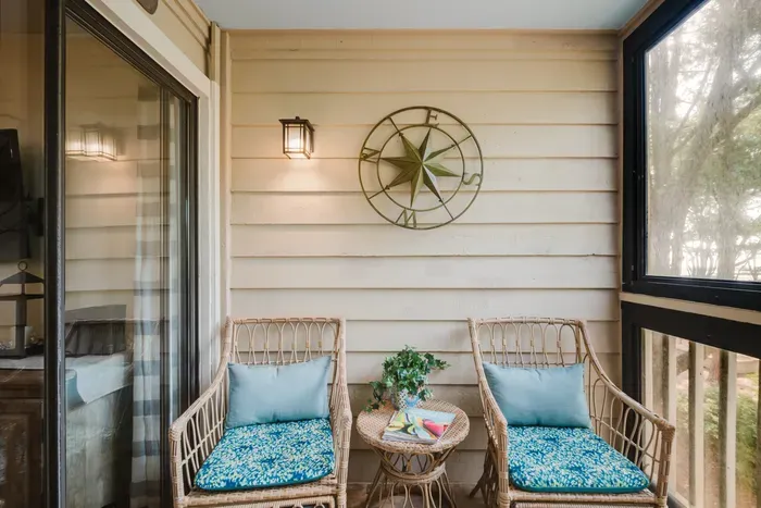 Cozy screened porch with wicker seating and peaceful woodland views