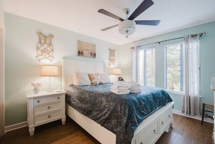 Bright, cozy bedroom with elegant decor and sunny window views