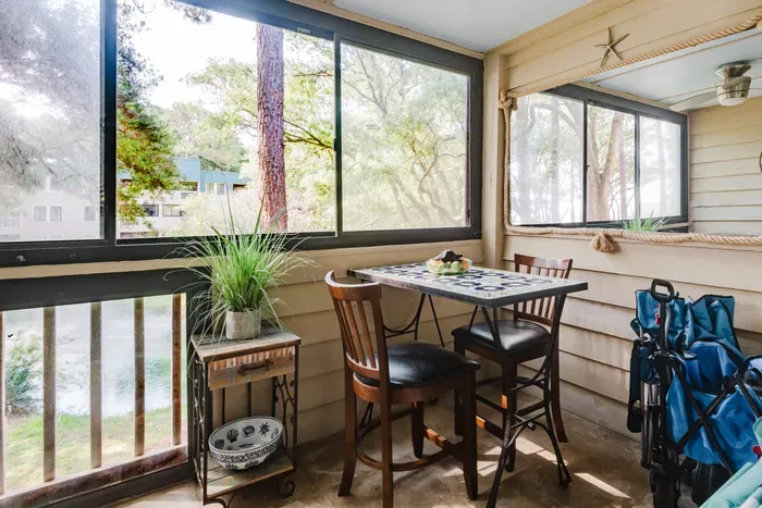 Screened porch with bistro dining and peaceful tree-filled views