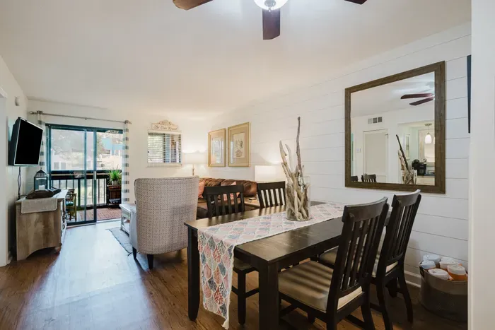 Bright coastal-style living space with dining area and private patio access