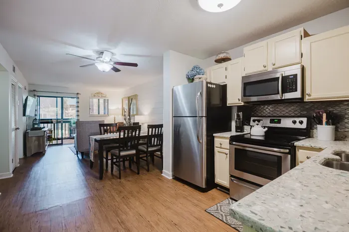 Bright open kitchen, dining area, and balcony access for easy relaxing