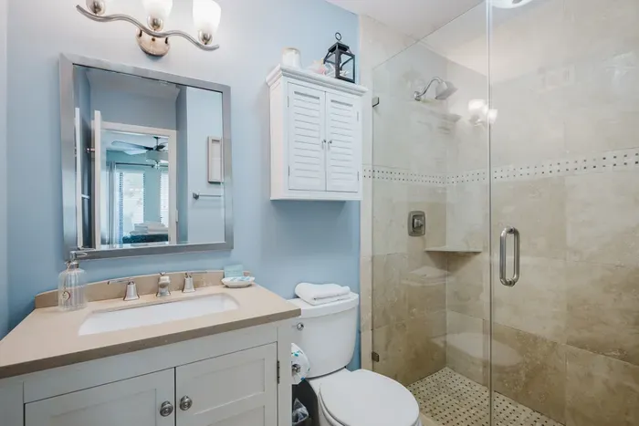 Bright spa-style bathroom with walk-in glass shower and modern vanity
