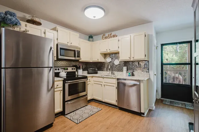Bright updated kitchen with stainless steel appliances and stylish finishes