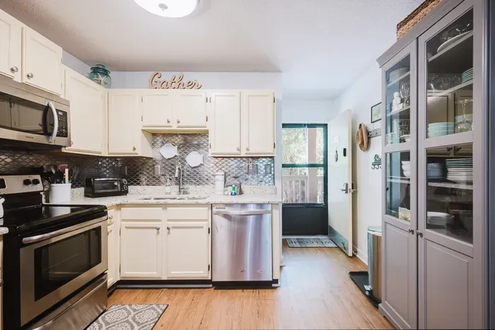 Bright kitchen with stainless appliances and charming farmhouse touches