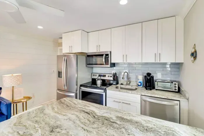 Granite Counter with stocked Kitchen including Keurig and Drip Coffee Makers.
