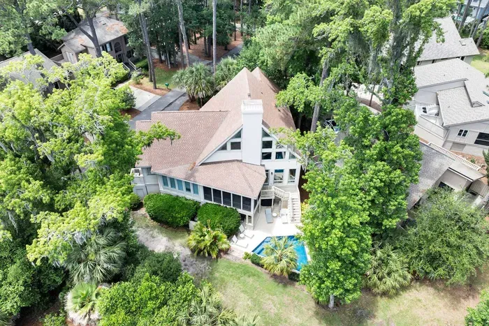 Mature oaks and palmettos on every side. Real privacy for a home this close to everything.