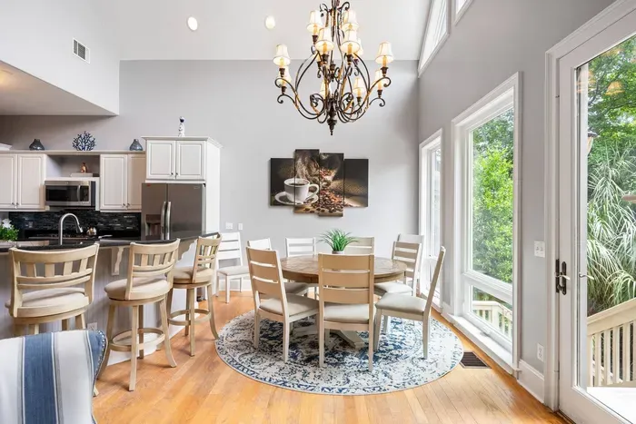Round dining table for six, four swivel stools at the bar, and a door to the screened porch right there.