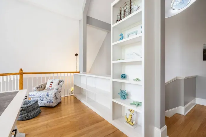 A reading nook and built-in shelving tucked into the loft landing.