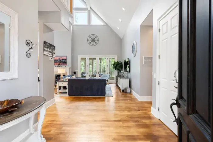 Step inside to soaring ceilings, warm hardwood floors, and light from every direction.