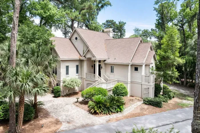 Tucked under live oaks, palms, and Spanish moss with mature landscaping on every side.