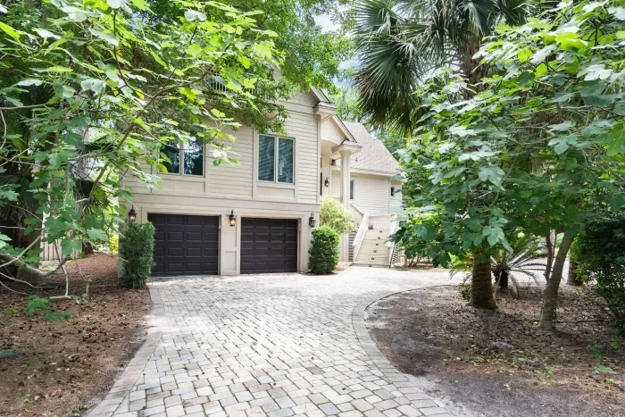 Two-car garage plus a wide paver driveway. Room for four vehicles with no shuffling.