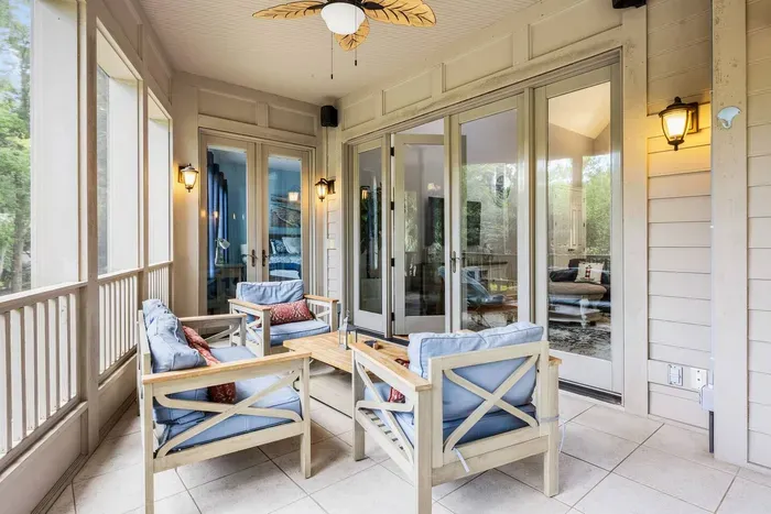 Two sets of French doors connect the porch to the great room and the primary suite.
