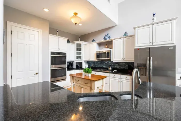Full-size fridge with ice and water, double ovens, and prep space for two cooks at once.