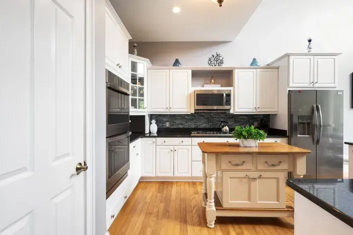 Double wall ovens, gas cooktop, and a butcher-block island. Thanksgiving-capable.