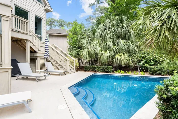 Loungers on the deck with the pool steps just there. Steps up to the screened porch.