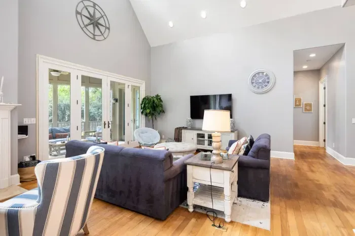 Deep sofas, a big flat-screen, and a hallway leading back to the main-floor bedrooms.