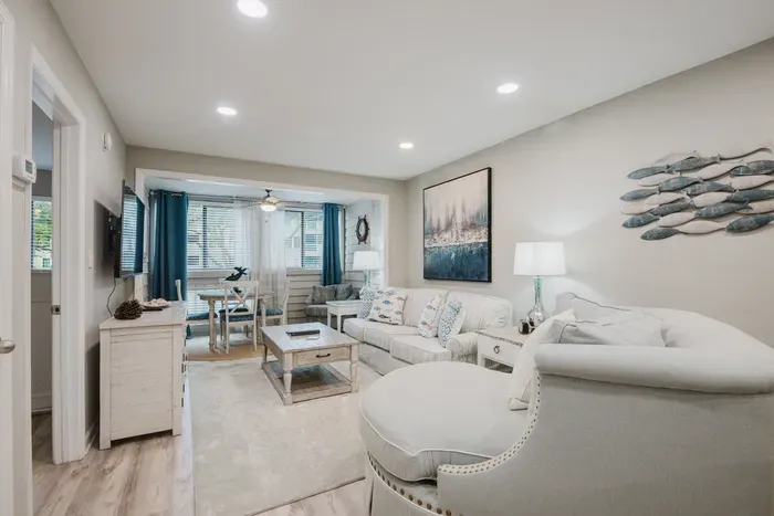 Deep, comfortable seating for the whole group, with the dining nook and windows just beyond.